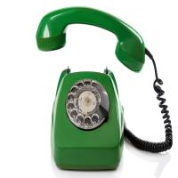 Graphic of a bright green, old-style telephone.